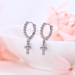 Detail showing S925 sterling silver stamp on minimalist beaded cross hoop earrings