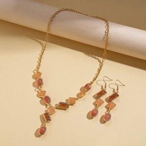 Vintage gold jewelry set with amber geometric resin pendants and crystal accents
