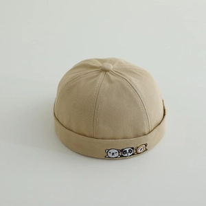 Close-up of khaki cotton baby docker hat featuring cute animal embroidery details