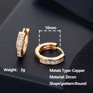 Detail of 10mm gold huggie earrings showing micro-pave square zircon settings