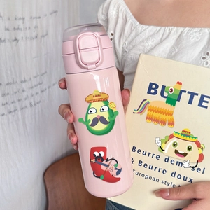 Detail of pink thermos with Mexican cartoon stickers held against a yellow background