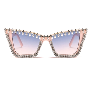 Pink cat-eye sunglasses featuring white pearls, double-row rhinestones and gradient lenses