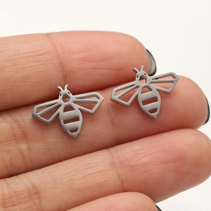 Minimalist hollow bee stud earrings in matte silver finish shown for size reference