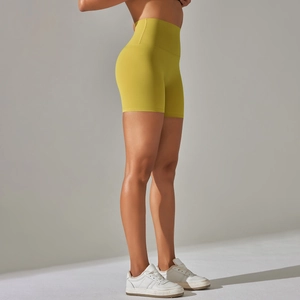 Detail of high waisted lime green yoga shorts with seamless wide waistband for tummy control