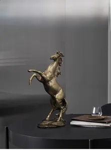 Detail of bronze rearing horse statue with muscular texture on a dark circular table