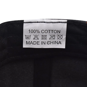 Detail view of the 100% cotton material tag and inner lining of the baseball cap