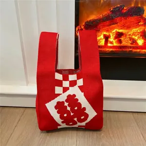 Detail of red knit tote bag with white checkerboard and Chinese Xi character motif