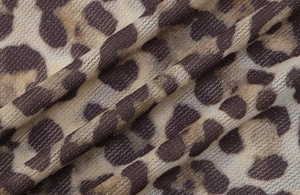 Close-up of leopard print mesh fabric showing breathable texture and pattern