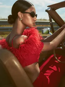 Detail of red off-shoulder set with fluffy feather trim and matching high-waist pants