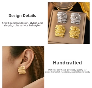 Detailed close-up of 18k gold hammered stud earrings with irregular wrinkled texture