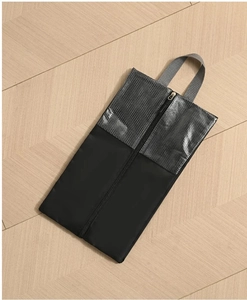 Detail of waterproof travel shoe bag with dual-texture fabric and center zipper design