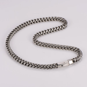 Macro detail of 8mm silver stainless steel chain necklace with square box clasp closure
