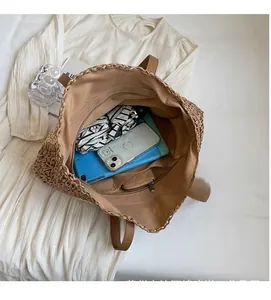Interior view of the woven straw beach bag showing large capacity for travel essentials