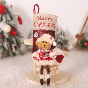 Detail of red Christmas stocking with 3D teddy bear and Merry Christmas embroidery