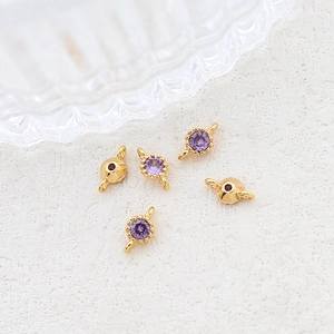 Detailed view of DIY gold-plated pendants with purple cubic zirconia and double loops