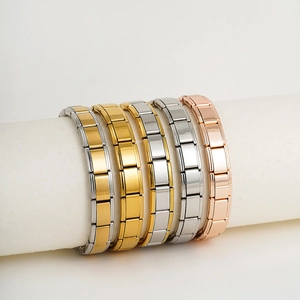 Stack of gold, silver, and rose gold stainless steel elastic modular link bracelets