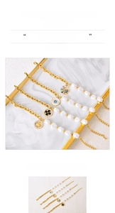 Detail of titanium steel gold bracelet with pearl accents and evil eye charms