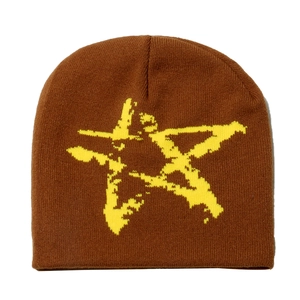 Detailed view of dark brown knitted beanie featuring a yellow star jacquard pattern