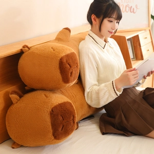 Brown Capybara long plush pillow case shown in a cozy home bedroom setting
