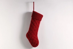 Detail of red cable-knit Christmas stocking with ribbed cuff and hanging loop hanger