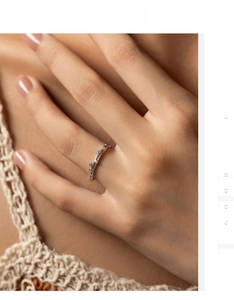Detail of S925 sterling silver double-layer crisscross ring with zircons on finger