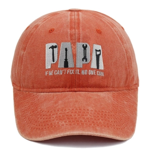 Macro detail of PAPA embroidery and fix-it slogan on washed brick red baseball cap