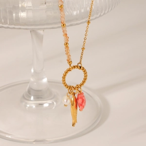 Golden ocean style necklace with fish, pearl, and coral charms on beaded steel chain