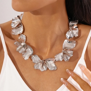 Detail of silver metallic flower petal necklace showing textured finish and choker fit