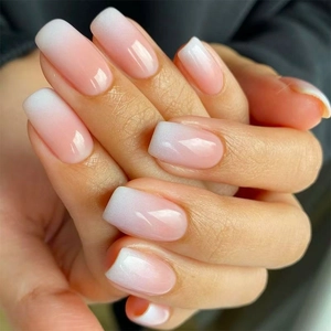 French ombre press-on nails in pink and white gradient with a glossy square oval finish