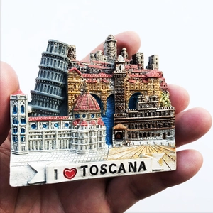 Hand holding a 3D resin Tuscany fridge magnet with Leaning Tower and Florence Cathedral