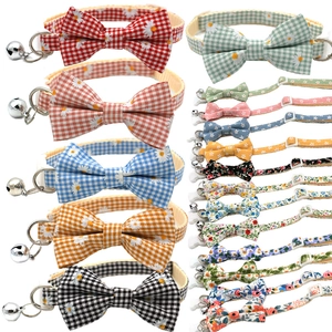 Detailed grid of colorful daisy and floral print pet collars with bells and bowties