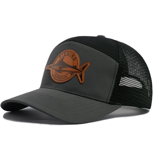 Mesh trucker hat with curved brim and leather shark fishing badge in dark grey