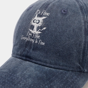 Detail of navy washed denim baseball cap with funny cat print and slogans