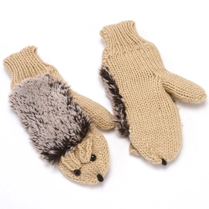 Closeup of cute hedgehog knitted winter warm mittens detail showing furry spikes and face.