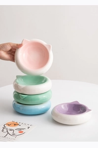 Detailed view of stackable cat-ear shaped ceramic pet bowls in five macaron colors