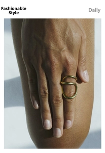 Macro detail of minimalist irregular double-loop 18k gold plated stainless steel ring