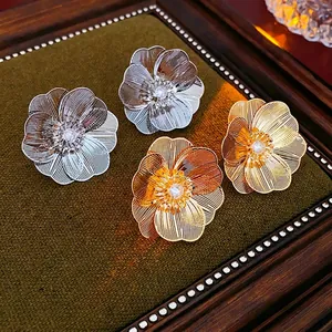 Vintage hollow flower stud earrings in gold and silver plating with zircon accents
