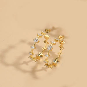 Detailed view of 14K gold-plated leaf hoop earrings with rectangular cubic zirconia