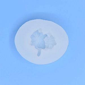 Maple leaf shaped silicone mold for DIY baking and cake decorating on blue background