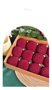 Detail view of 6cm burgundy velvet Christmas balls with embossed texture in gift box