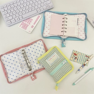 Detail of Korean style padded fabric A7 binder cover with 6-ring metal binder and zipper