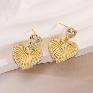 18K gold plated heart drop earrings with white zircon accents on minimalist white display