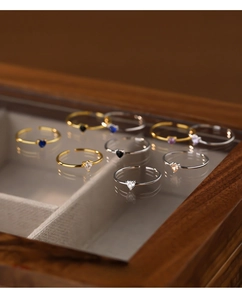 Detail shot of S925 sterling silver heart rings with colorful zircon in a luxury wood box