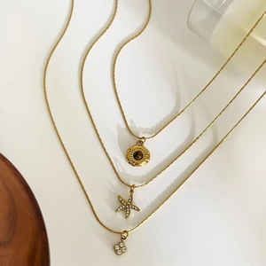 Gold stainless steel necklaces featuring sunburst tiger eye and starfish pendants