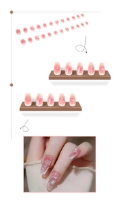 Detail view of pink gradient press-on nails with 3D pearls and rhinestone decorations