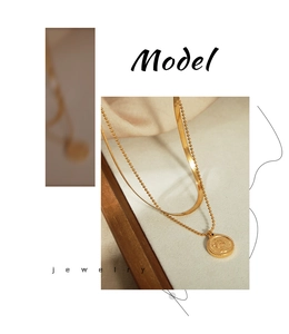 Detail of vintage double-layer gold anklet with coin pendant and herringbone chain