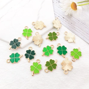Macro detail of colorful four-leaf clover alloy pendants for DIY jewelry making accessories