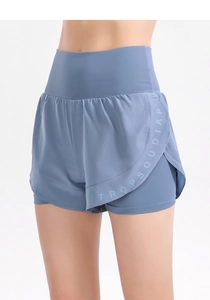 Macro detail of high-waist foggy blue sports shorts with quick-dry texture and curved hem