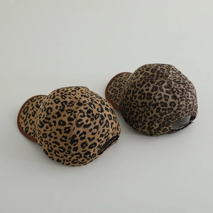 Detailed view of leopard print kids baseball caps in light tan and dark brown tones