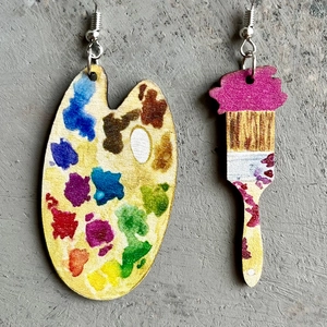 Artistic wooden teacher earrings with palette and paintbrush design on concrete surface